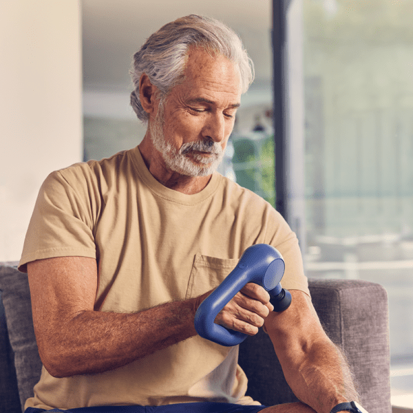 Theragun Relief Blue massaging the Bicep of man